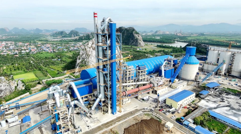 Blue cement plant near limestone karst mountains in Hai Phong, Vietnam