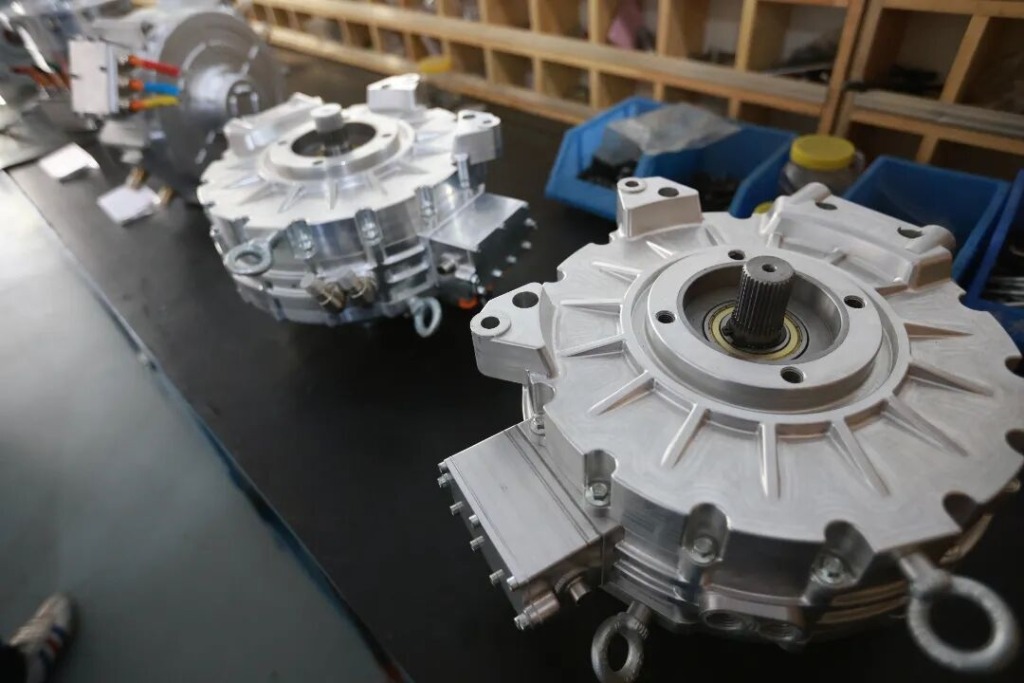 Two aluminum axial-flux motors on a workbench