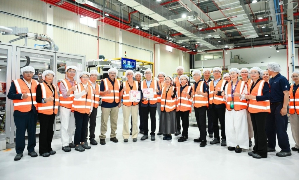 Kimberly-Clark team in orange safety vests inside Nanjing factory